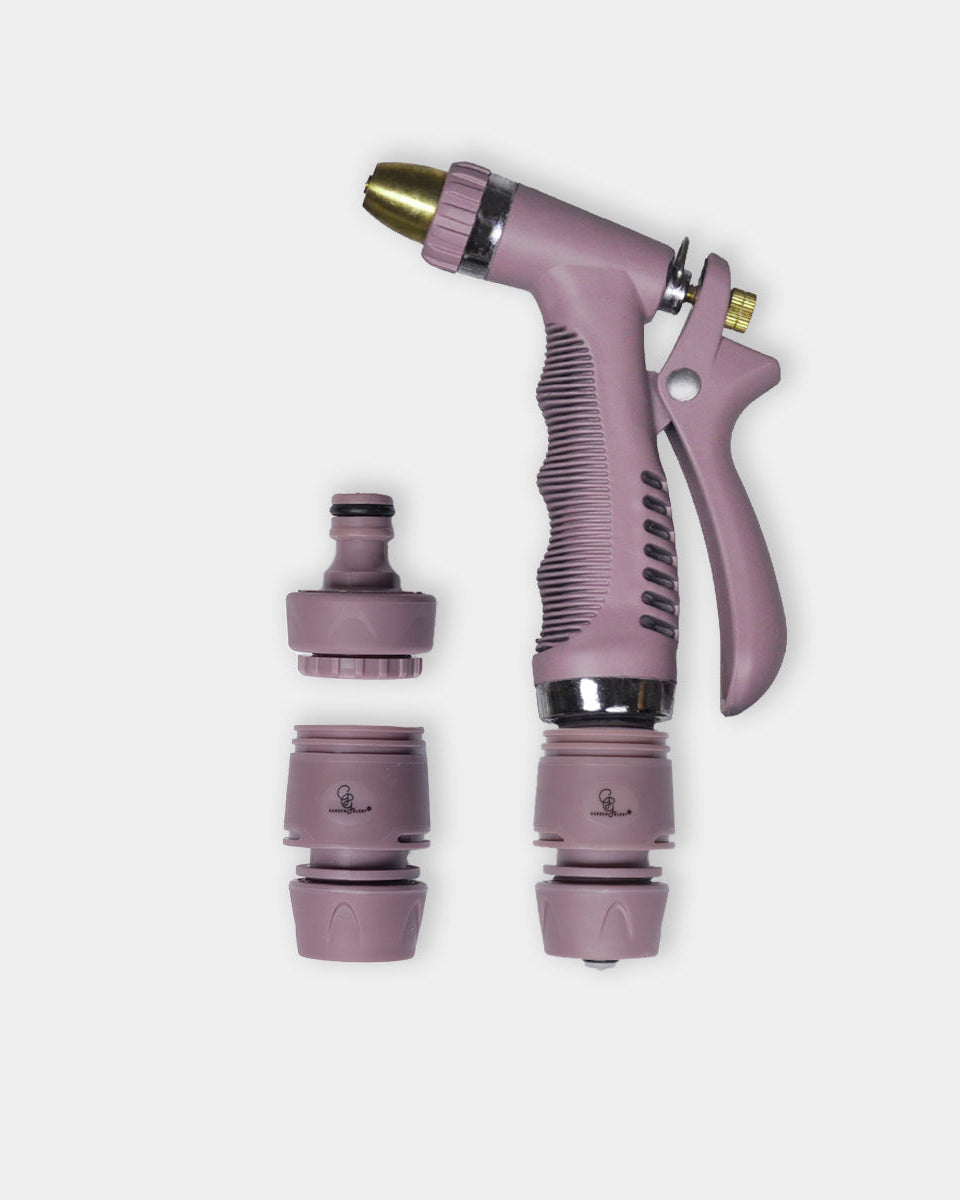 A lavender-purple spray nozzle with a textured grip, gold-toned metal tip, and three interchangeable hose connectors shown separately on a light gray background.