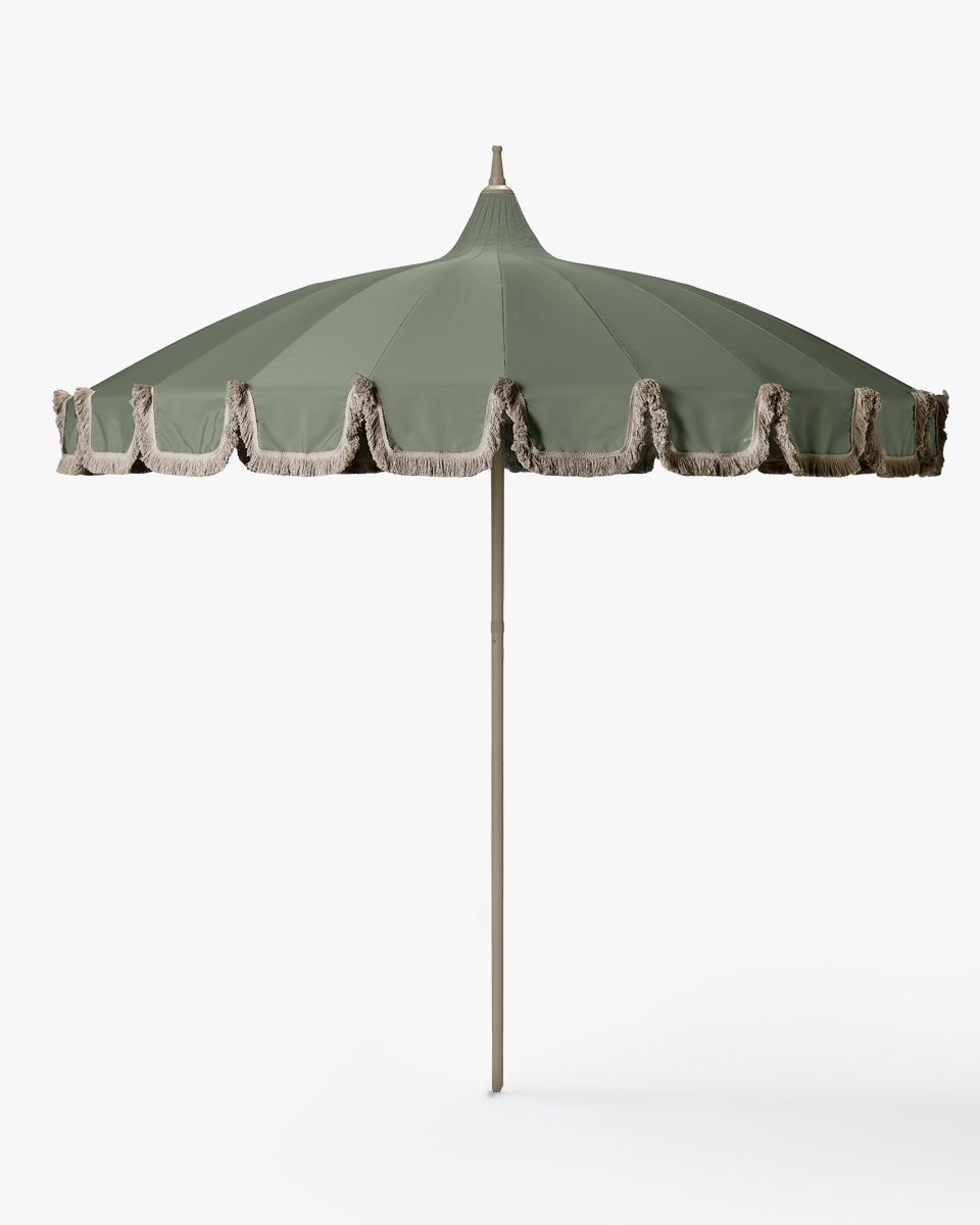 Green patio umbrella with decorative trim on a white background