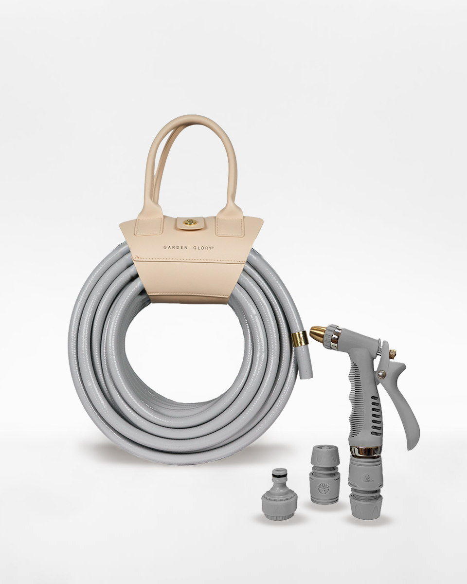 Gray garden hose with a beige carrying case and spray nozzle on a white background