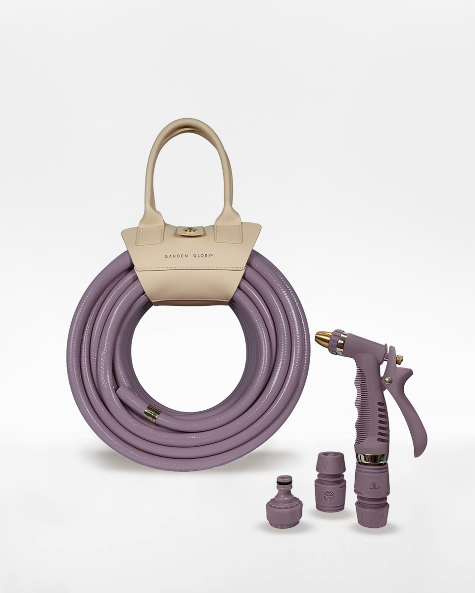 Purple garden hose set with beige handle and nozzles on a white background