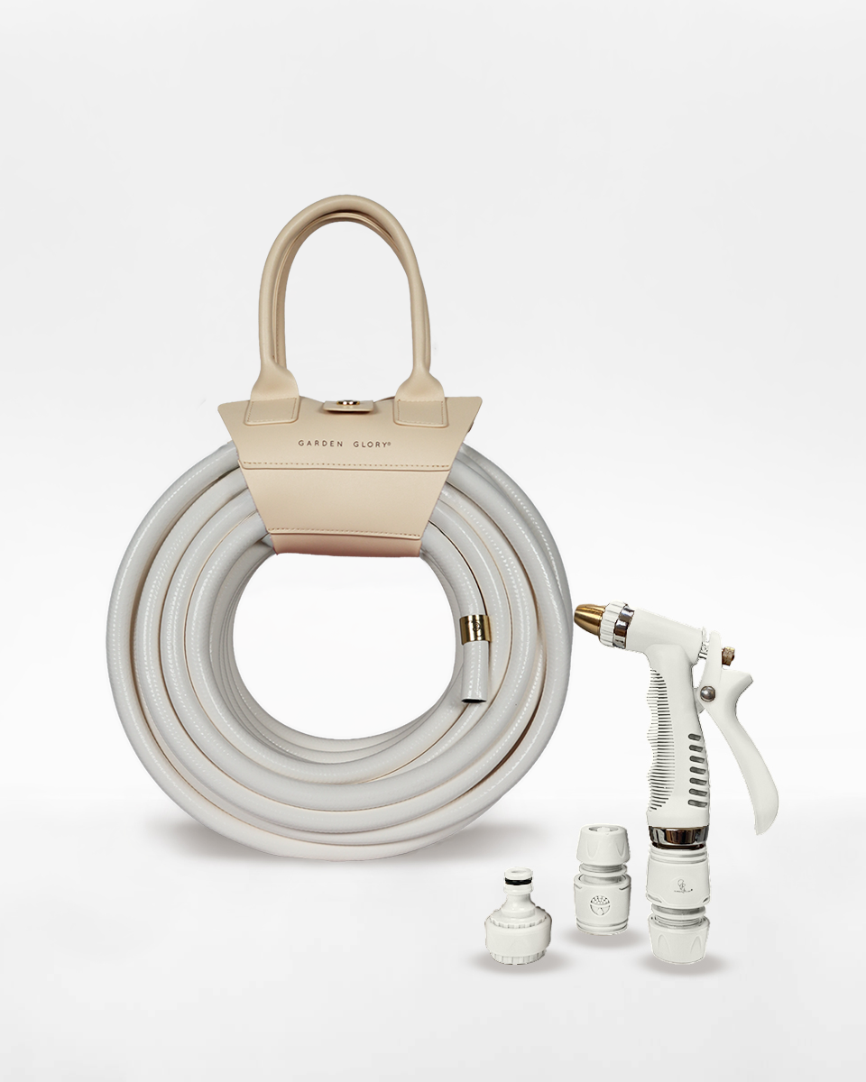 Garden hose with spray gun and accessories on a white background