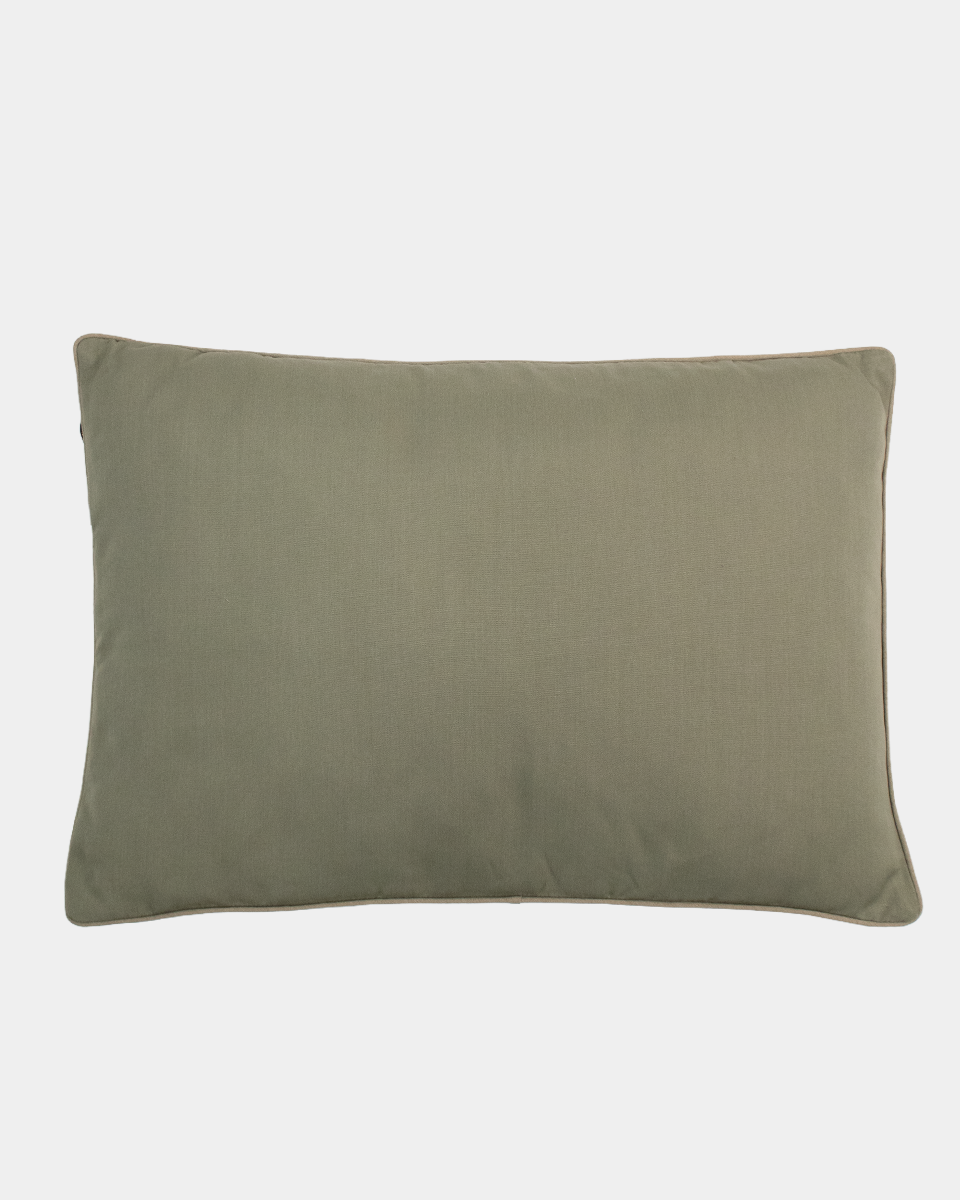A rectangular green pillow with piped edges, photographed flat against a light gray background.