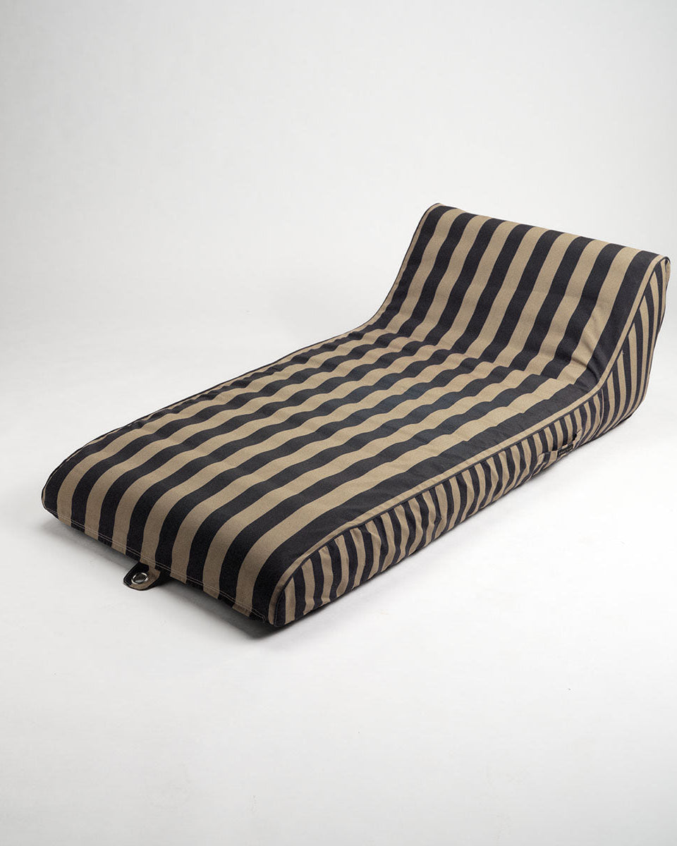 Striped sun lounge with black and beige pattern on a white background