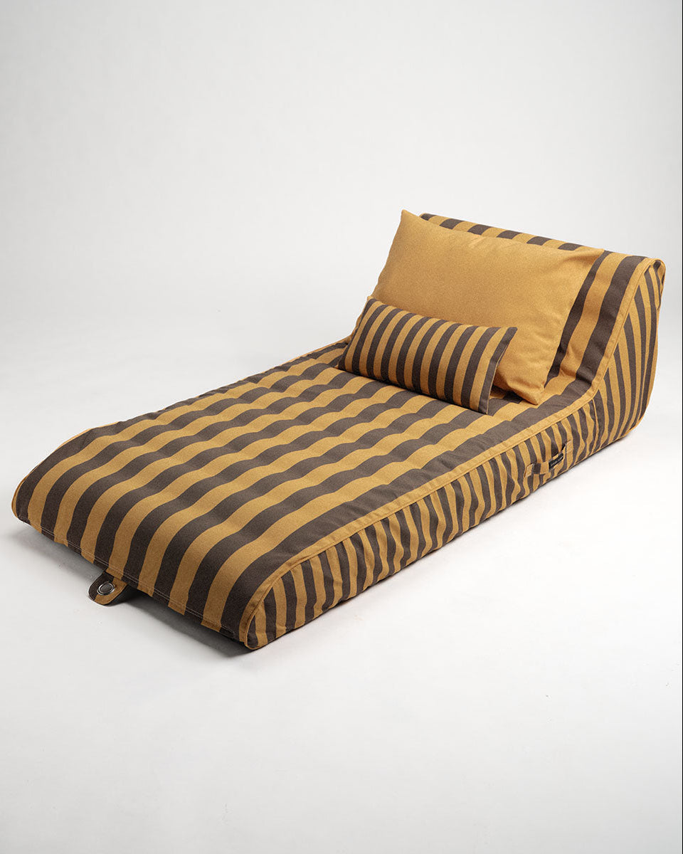 Striped sun lounge with a pillow on a white background
