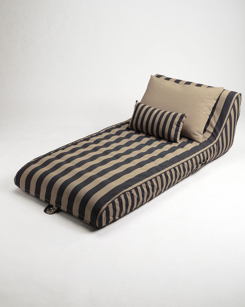 Striped sun lounge with cushions on a white background