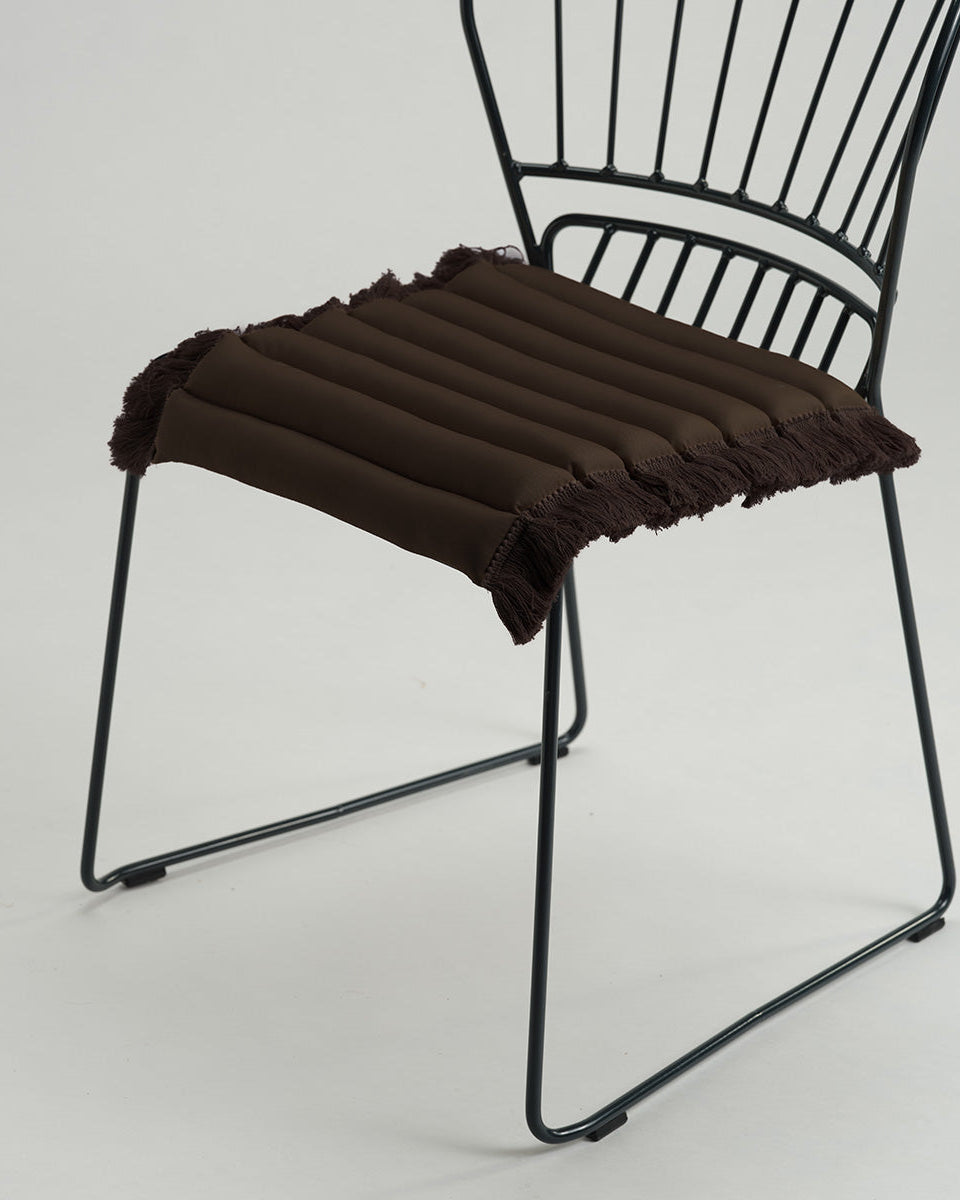 Black metal chair with a brown cushion on a white background