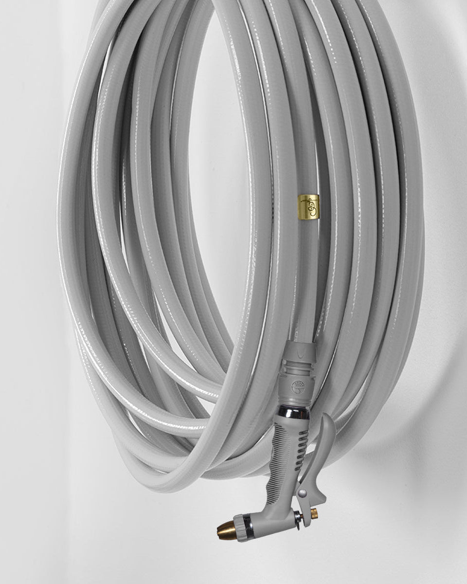 Gray garden hose with a spray nozzle on a white background