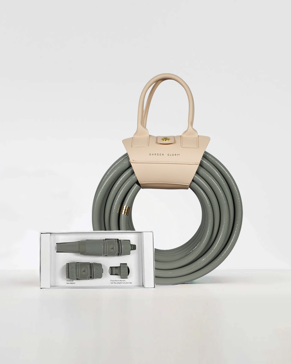 Eucalyptus green garden hose with connectors and a beige handbag on a white background