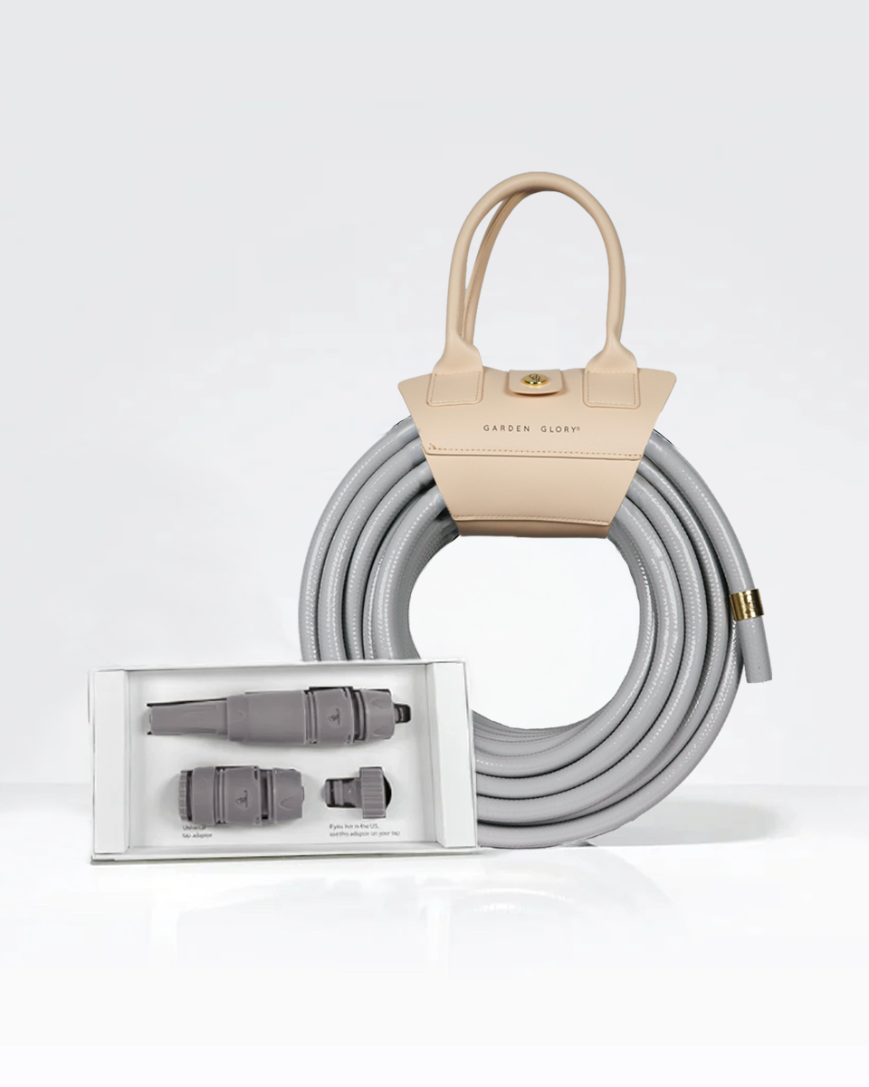 Gray Garden hose with spray nozzle white background