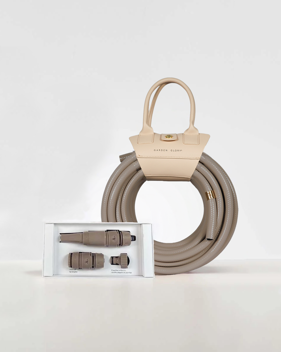Beige garden hose with connectors on a white background
